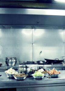 close-up of a commercial kitchen, showing food bowls placed on a table
